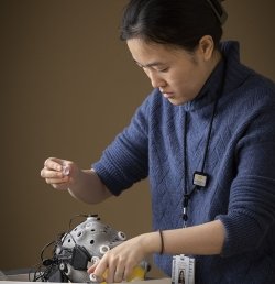 A research assistant at the Marcus Institute for Aging Research in Boston prepares a cap used to measure brain activity.