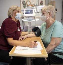 A study coordinator at the Marcus Institute for Aging Research in Boston takes the vital signs of a study participant.