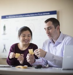 Two researchers at the Marcus Institute for Aging Research in Boston, MA examine insoles that can track a person's gait.